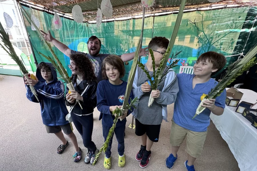 students celebrating sukkot in a sukkah